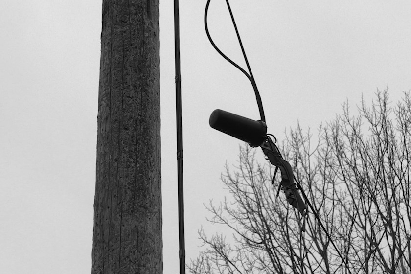 Telephone pole with broken line and connection point loose from its mount [photo: Henrik Hemrin]